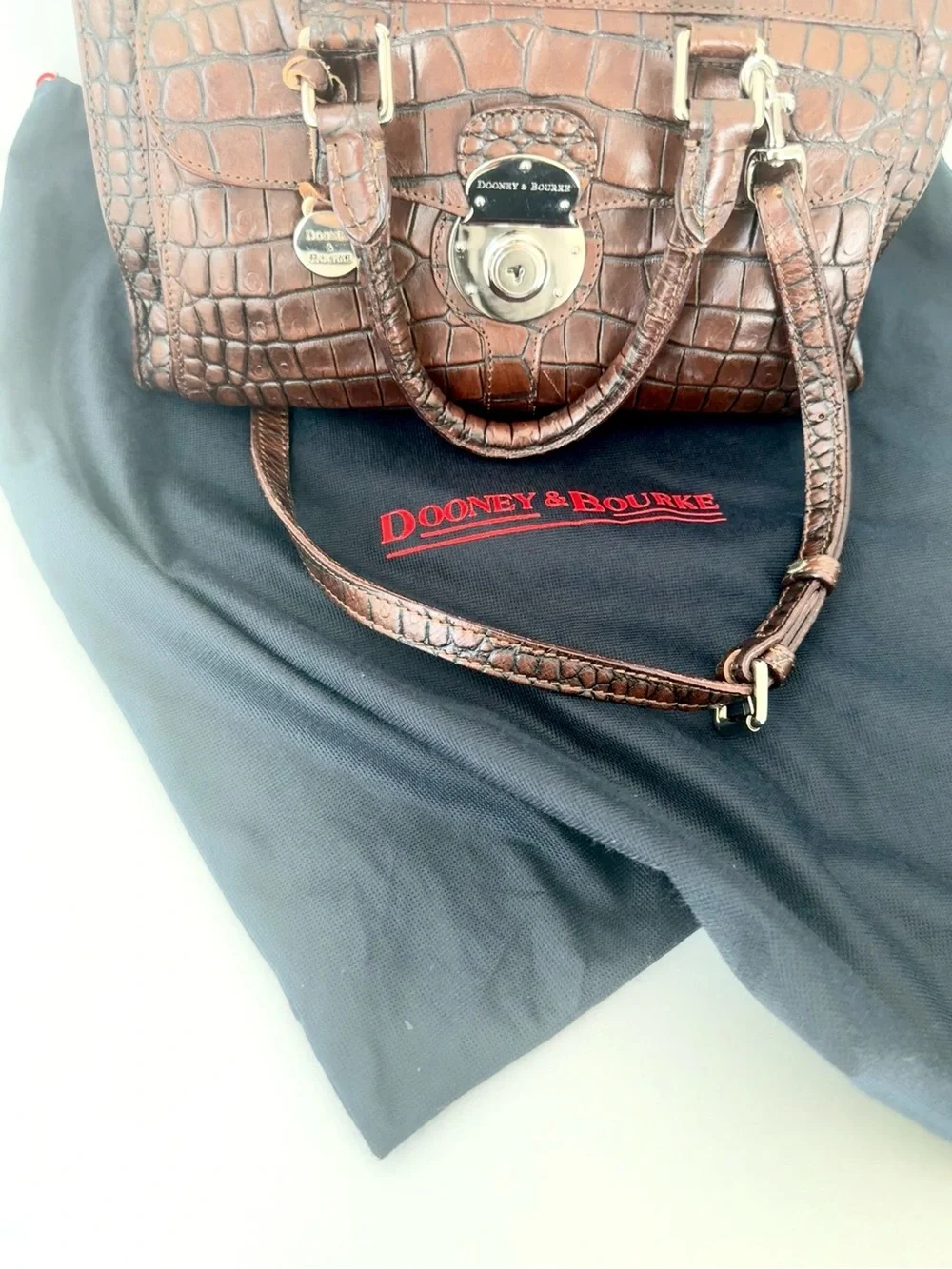 Dooney & Bourke, crafted from rich brown crocodile-embossed leather